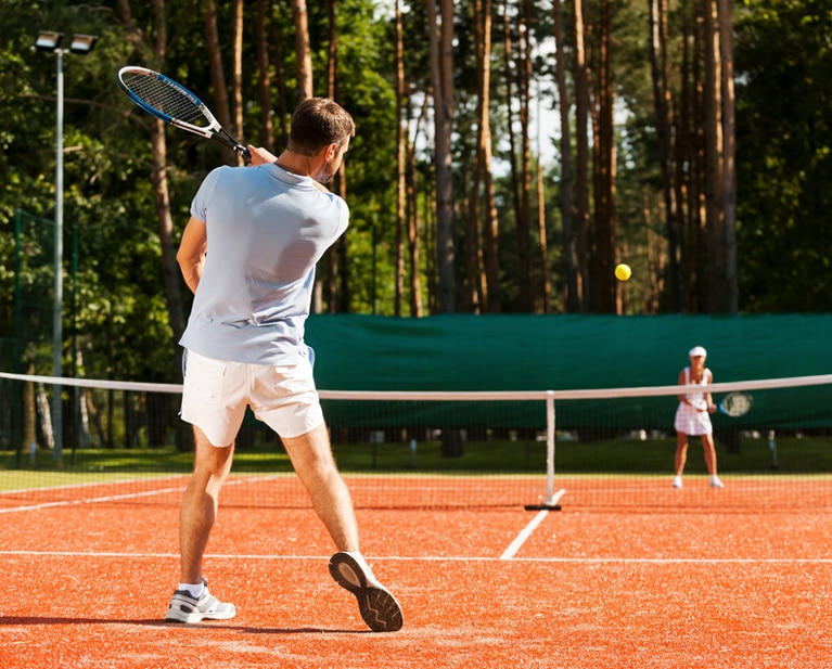Man and woman tennis players practicing injury prevention