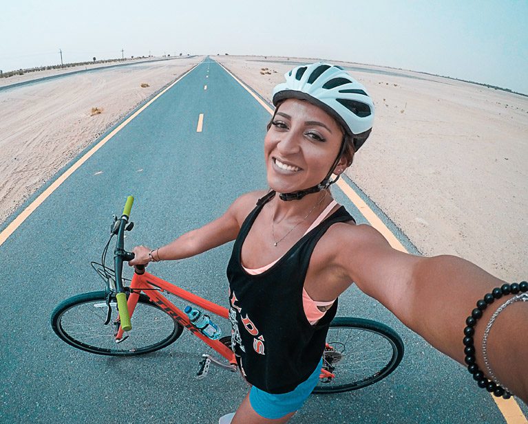 woman on bike to decrease chronic pain with exercise